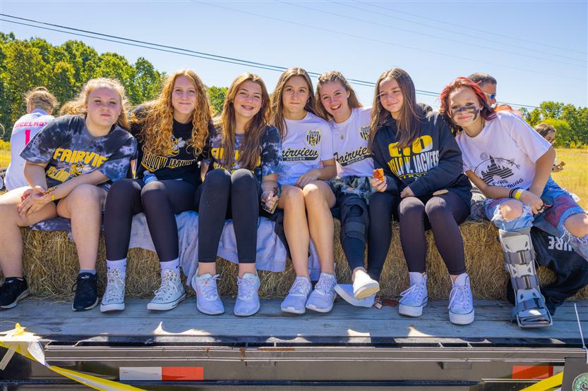 Students ride on a homecoming float